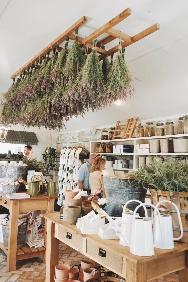 Interior of a shop with hanging bundles of dried herbs and flowers